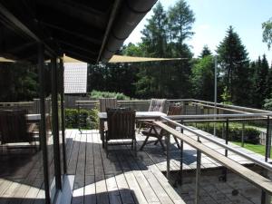 a patio with chairs and a table with an umbrella at Holiday home Huus Adele in Silberborn