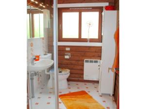 a bathroom with a toilet and a sink at Holiday home Schleiblick in Gunneby