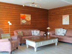 a living room with two couches and a coffee table at Holiday home Schleiblick in Gunneby +2 photos