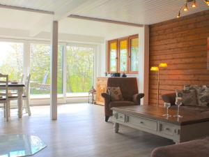 a living room with a couch and a table at Holiday home Schleiblick in Gunneby
