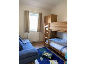 a living room with a bunk bed and a couch at 2 Zierow on the Baltic Sea in Zierow