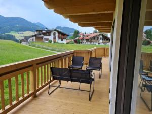 a balcony with chairs and a view of the mountains at Green Residence XL in Wildschönau