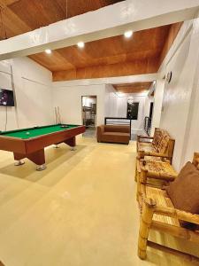 a living room with a pool table and couches at Bahai ni Jhane in Calatagan