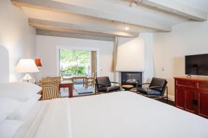 1 dormitorio con cama blanca y chimenea en Wine & Roses Hotel Restaurant Spa Lodi, en Lodi