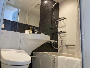 a bathroom with a toilet and a sink and a shower at RJ HOTELS OTARU in Otaru +18 photos