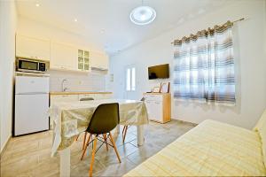 a kitchen with a table and a dining room at Apartments with a parking space Postira, Brac - 22150 in Postira