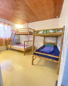 a room with two bunk beds in a room at Bahai ni Jhane in Calatagan