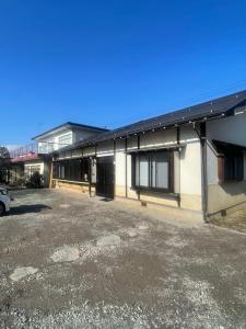 an empty parking lot in front of a building at Five Peaks Yudanaka in Yamanouchi