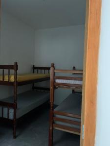a group of bunk beds in a room at Casa Esmeralda in Guaratuba