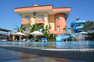 a resort with a pool and a water slide at Yavuzhan Hotel in Side