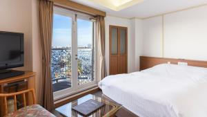Postel nebo postele na pokoji v ubytování kisarazu bay Town Hotel + 26 fotografií