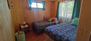 Postel nebo postele na pokoji v ubytování Cabaña Pinos del Mar