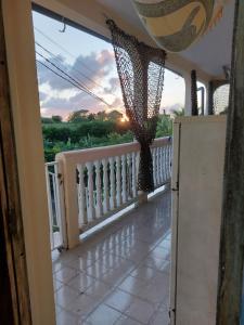 a balcony with a view of the sunset at La Jéméli in Grand-Bourg