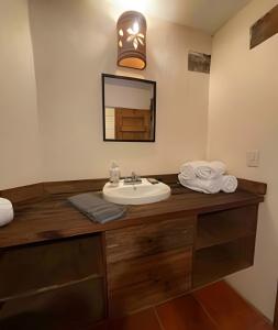 W łazience znajduje się umywalka i lustro. w obiekcie Cabaña Bechamel, Tapalpa w mieście Tapalpa