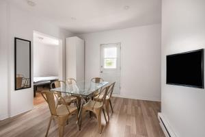 a dining room with a glass table and chairs at 2 bedroom apartment - 1007 in Montreal