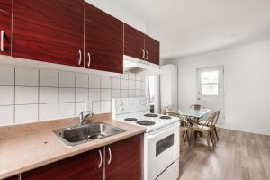 a kitchen with a sink and a stove and a table at 2 bedroom apartment - 1007 in Montreal