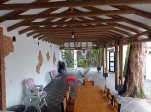 a room with a wooden table and chairs and a tree at Quinta Villateo in Villavicencio
