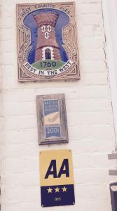 a sign on the side of a building with a lighthouse at Walter de Cantelupe Inn in Worcester