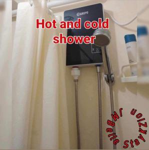 a sign that says hot and cold shower in a room at Katas ng Japan Staycation Studio Unit in Manila