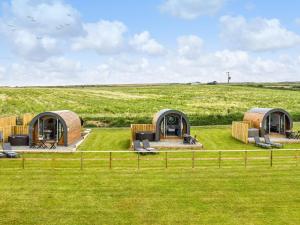 a group of three yurt homes in a field at Traeth Pod - Uk46077 in Towyn