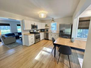 a kitchen with a table and a dining room at Quiet Family Friendly Home w/ Backyard [Owls Nest] in Tremont