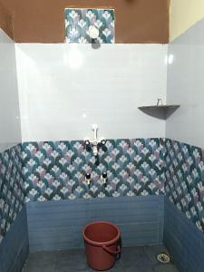 a bathroom with a flower pattern on the wall at Morje Coco Beach Stay in Gokarn