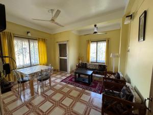 a living room with a table and a fireplace at Nivriti (Bliss) Homestay in Guwahati
