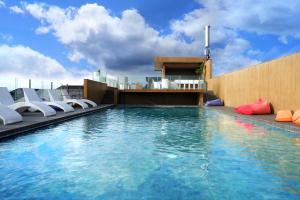 a swimming pool on the roof of a building at Stark Boutique Hotel and Spa in Kuta