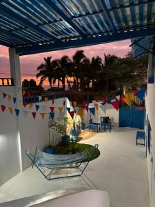 a patio with a view of the ocean and palm trees at Villa Aqua Boutique Vichayito in Vichayito