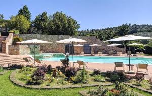 una piscina con sillas y sombrillas en un patio en Cozy Home In Montebuono With Kitchen, en Agello