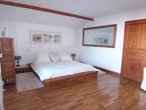 1 dormitorio con 1 cama con sábanas blancas y suelo de madera en Villa Arcachon, 6 pièces, 10 personnes - FR-1-374-12, en Arcachon