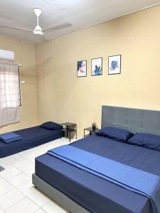 a bedroom with a large blue bed in a room at ~Big House UITM Hospital 11 Pax~ in Shah Alam +54 photos