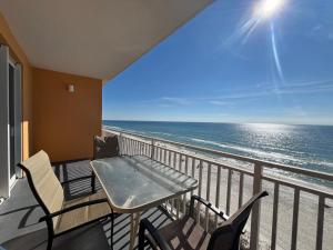 a balcony with a table and chairs and the ocean at Panama City Beach Ocreanfront 2BR in Splash Resort 402W in Panama City Beach