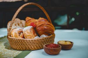 a basket of bread and pastries on a table at The Sebali Resort in Ubud