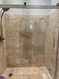 a shower with a glass door in a bathroom at The Scandinavian Contemporary Goud in Lake Alfred