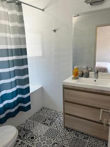 a bathroom with a sink and a toilet and a mirror at Cabaña en Puerto Varas, Chile. in Puerto Varas