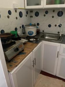 cocina con encimera, fogones y fregadero en Sandcastle Villa, en Weligama