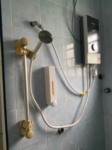 a shower head on a wall in a bathroom at Homestay Dyzas in Batu Caves