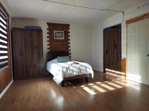 Ένα ή περισσότερα κρεβάτια σε δωμάτιο στο Alojamiento Punta Arenas