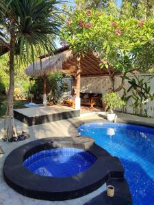 a swimming pool in the middle of a yard at Gili Moonlight Retreat in Gili Air