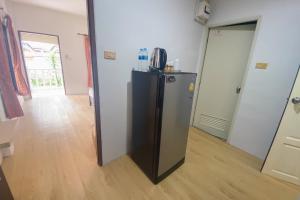 a small refrigerator in a room with a hallway at House No.2 Village in Krabi