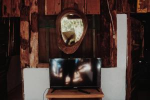 a tv sitting on a table with a mirror at Garden Cabins in Zipolite