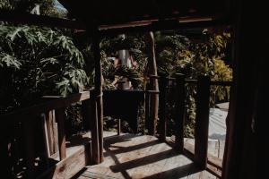 a wooden porch with a fence and some plants at Garden Cabins in Zipolite