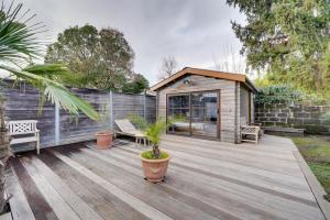 a backyard with a wooden deck with a shed at Superb loft Bordeaux in Bordeaux