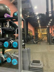 a gym with a rack of dumbbells in a room at The Everich Infinity 290 ADV in Ho Chi Minh City