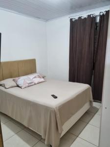 a bedroom with a large bed with a white bedspread at Casa da Karin in Torres