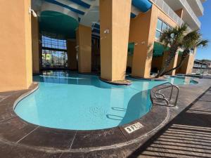 a large swimming pool in the middle of a building at Panama City Beach Ocreanfront 2BR in Splash Resort 402W in Panama City Beach