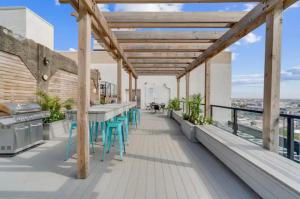 een patio met tafels en stoelen op een dak bij Comfy Apt, Rooftop Pool & Deck & Amenities in Philadelphia