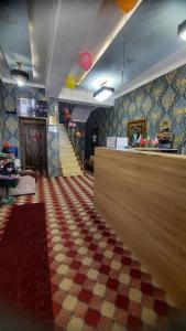 a restaurant with a checkered floor and a food counter at Зона отдых APACHI в горах ЧИМГАН in Chimgan
