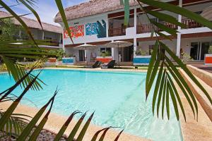 a swimming pool in front of a house at Amihan Resort in Panglao